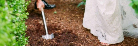 Digging up the bottle on the wedding day - photo via Merriment Events